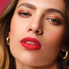 Woman with voluminous lips wears red lipstick