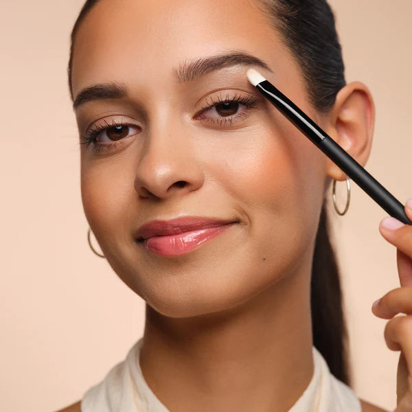 Model is applied highlighter with a brush