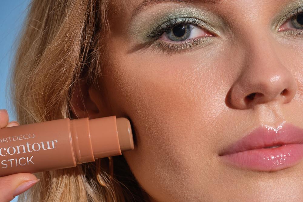 Model holds the ARTDECO Contour Stick with creamy texture