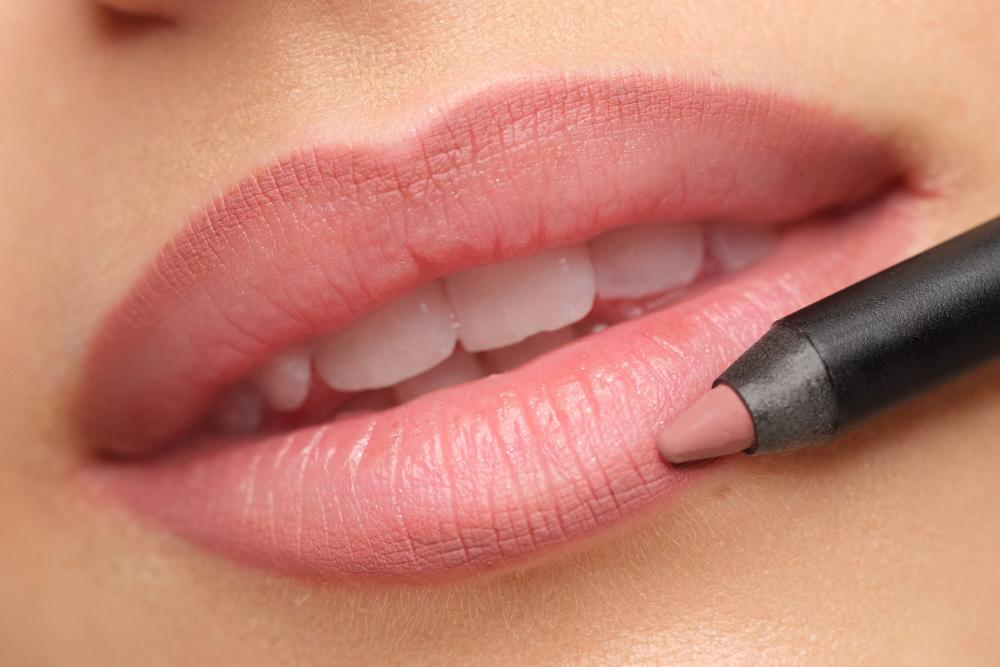 Make-up lips are shown, with a lip liner being demonstrated for application