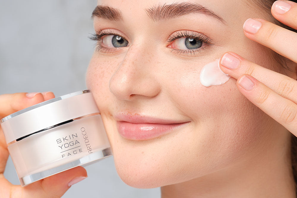 A face cream is being applied to the face