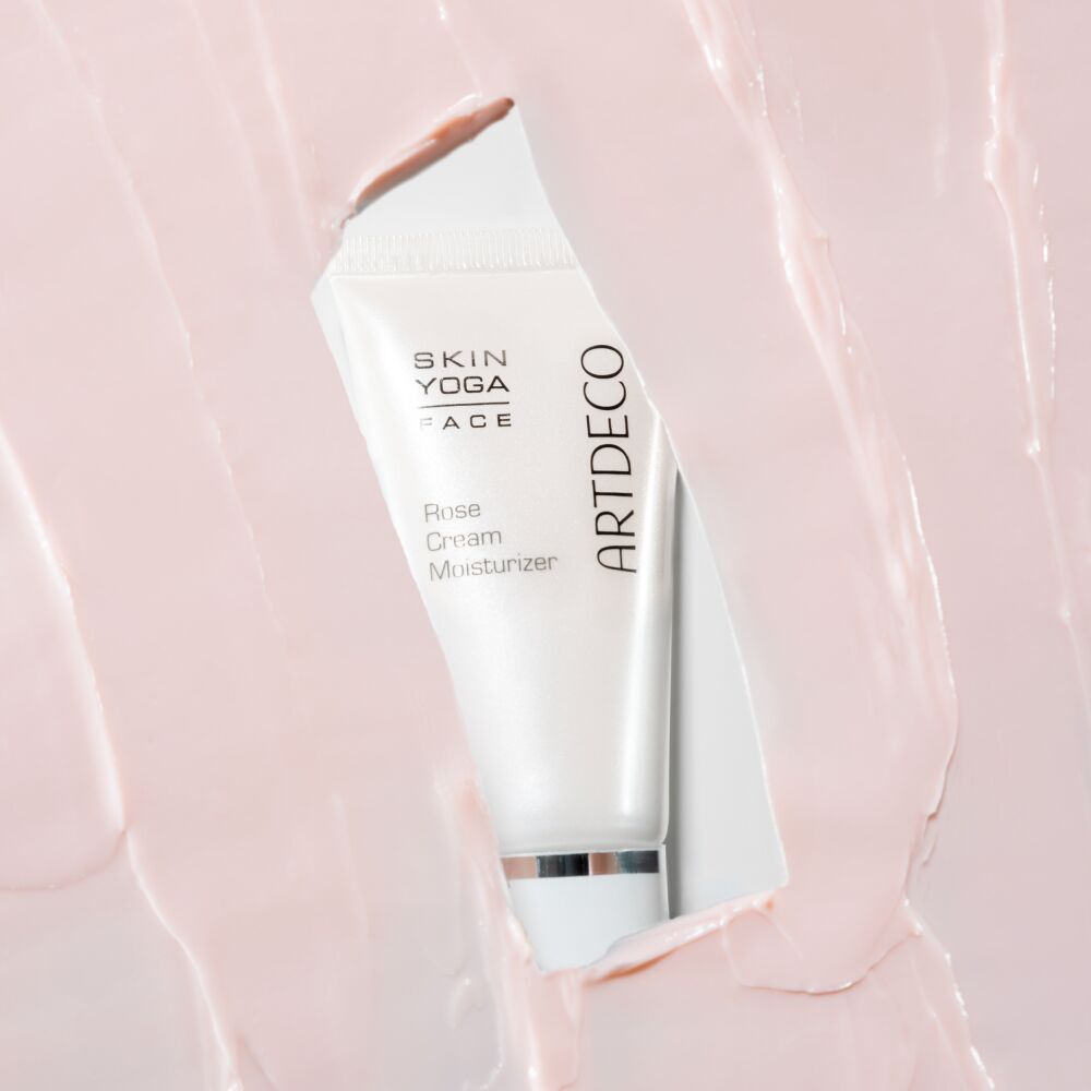 Rose Cream Moisturizer surrounded by the pink texture of the skincare product