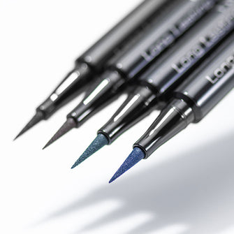Four colors of the Long Lasting Liquid Liner Intense float in the air and cast shadows.