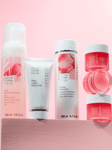All the products from the "My Skin Kissed by a Rose" facial care line against a pink background