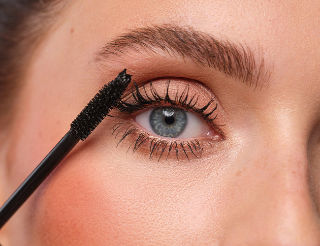 Close-up of the model's blue eyes applied with waterproof mascara.