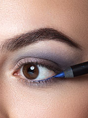 Blue kajal is applied to the lower waterline.