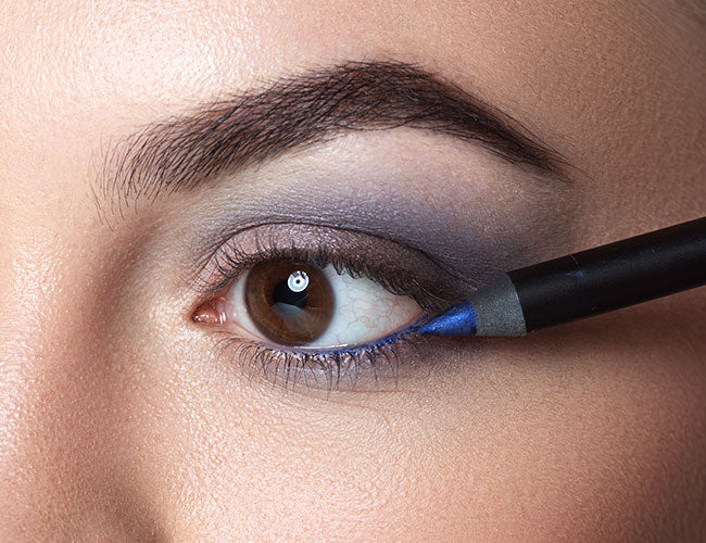 Blue kajal is applied to the lower waterline.