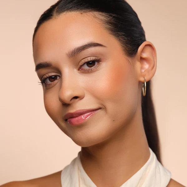 Woman with peach blush on cheeks for a fresh look