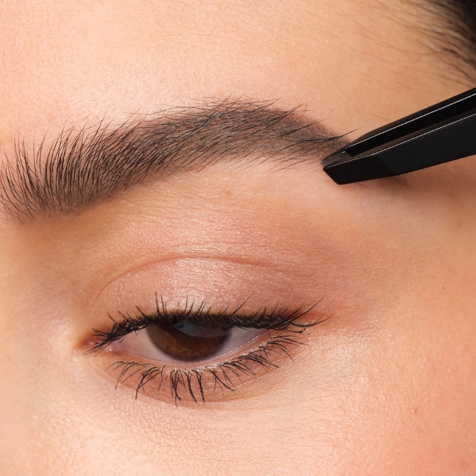 Eyebrows are plucked with tweezers.