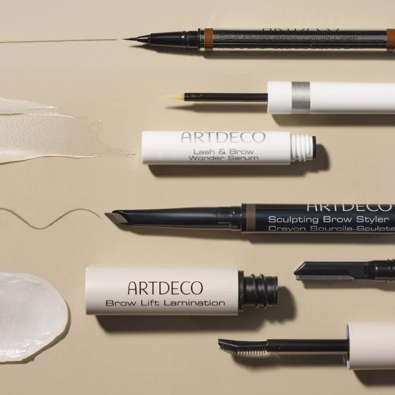 Various ARTDECO eyebrow products for different eyebrow needs with texture swatch on a beige background.