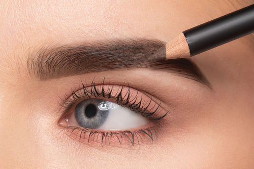 An eyebrow is repainted with an eyebrow pencil