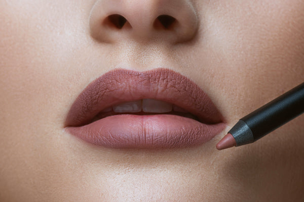 Lips made up are shown, with a lip liner demonstrated for application