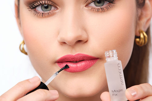 The lipstick is fixed with the Magic Fix, which is held in front of the face