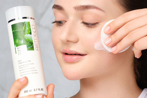 Facial cleanser is applied to the face using a cotton pad