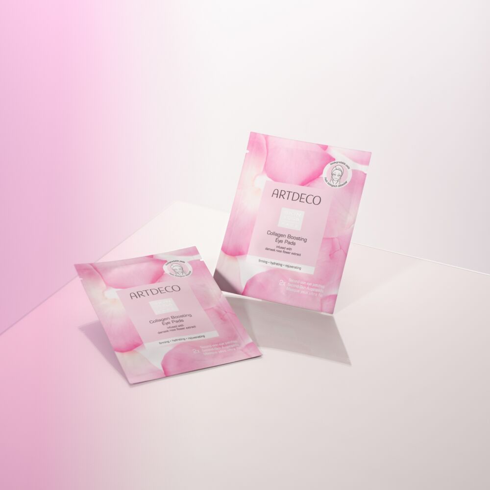 Two Collagen Boosting Eye Pads on a pink background