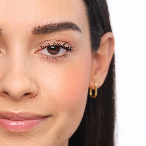 Made-up face with filled-in and defined eyebrows.