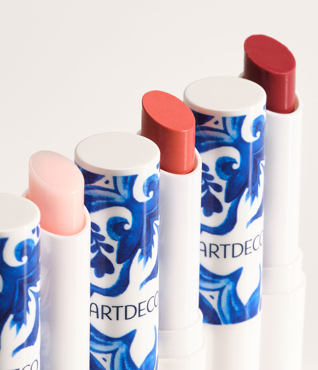 Close-up of a Color Booster Lip Balm product line in the limited edition design and all the available colors