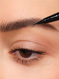 Sparse areas of the brows are filled in using the 24h Micro Brow Liquid Liner.