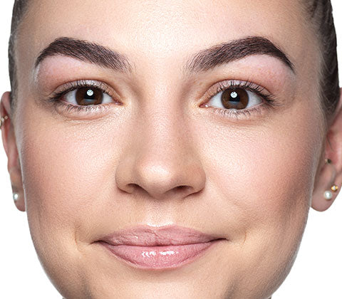 Smiling model without makeup looks into the camera.
