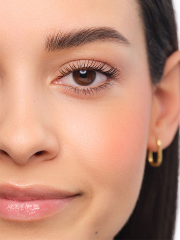 Made-up face featuring fluffy brows in the Feather Brow style.