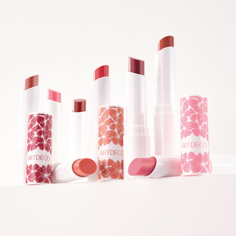 All eight shades of the Color Booster Lip Balm, featuring a limited-edition floral design