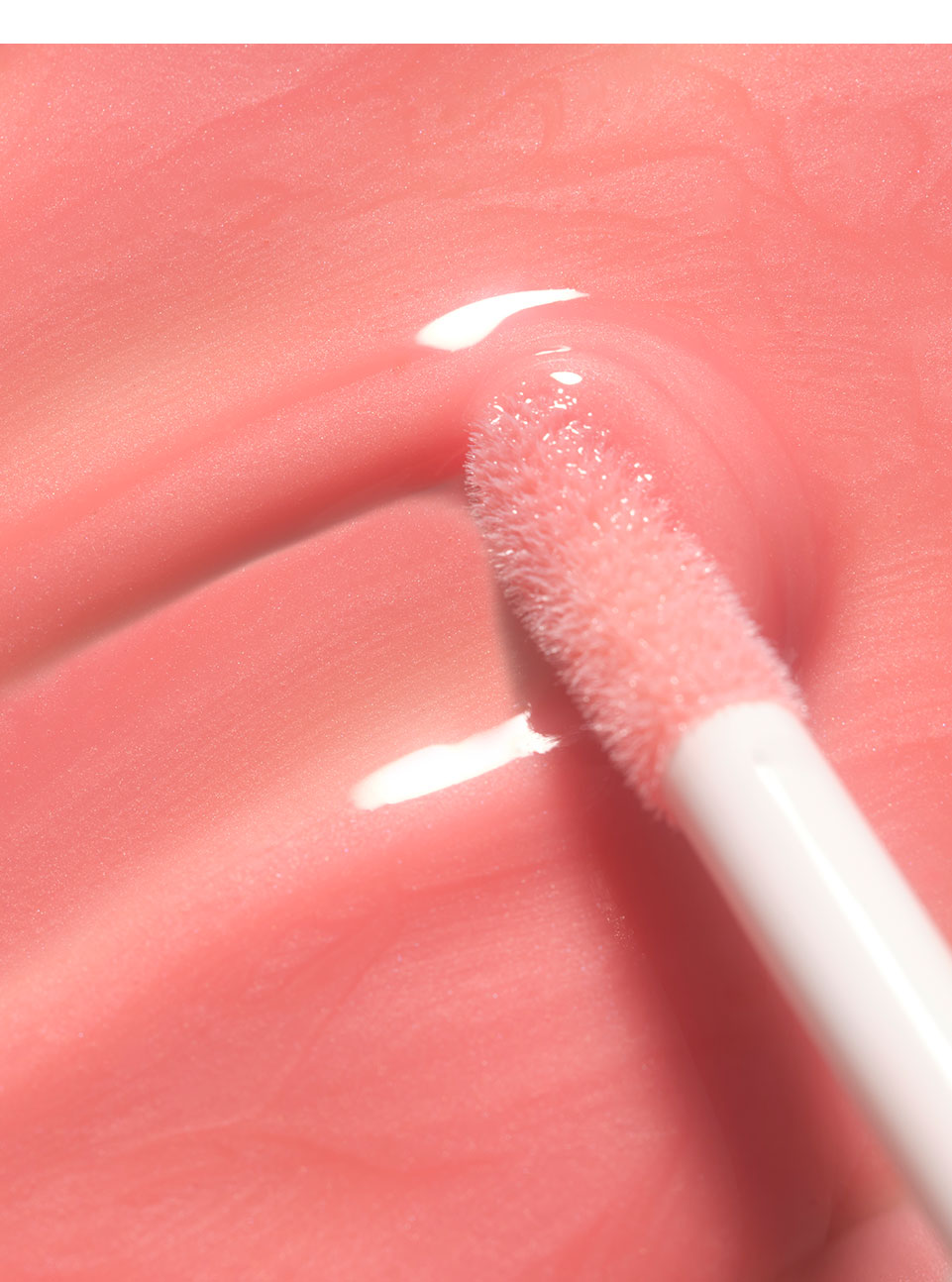 Aesthetic texture swatch of the new Lip Wonder Serum in peach.