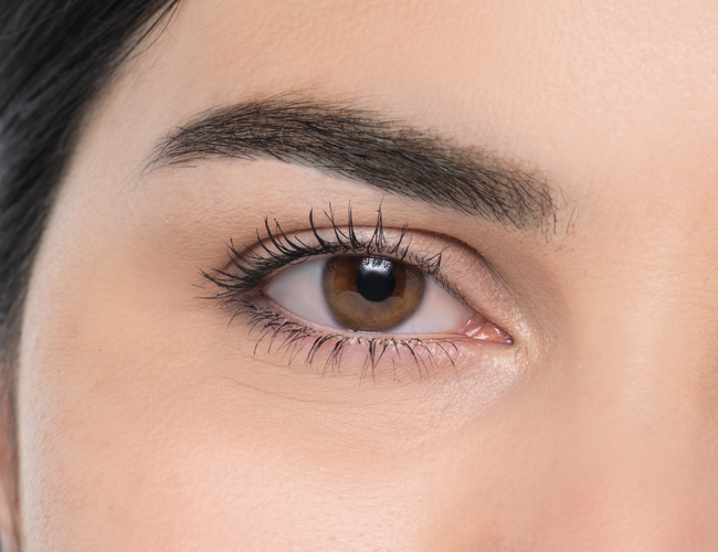 Close-up on the model's eye to show how to create a defined eyebrow