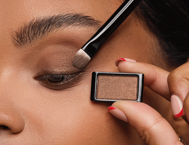 Darker eyeshadow is applied to define and intensify the eye makeup