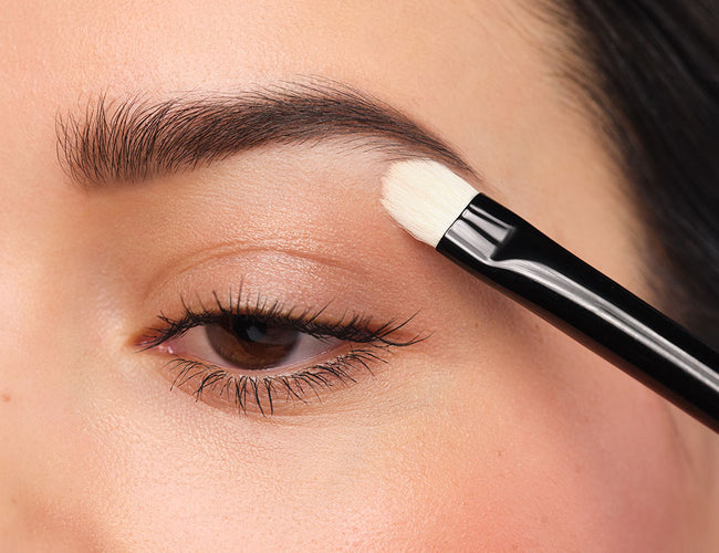 A light eyeshadow is applied under the eyebrows.