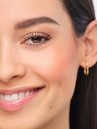 Smiling model with perfectly plucked eyebrows.