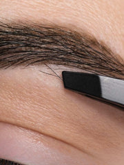 Eyebrows being plucked with tweezers.