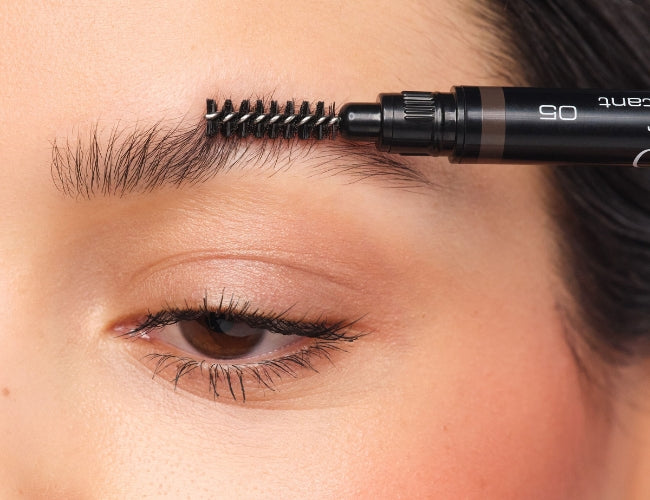 Eyebrows being combed beforehand to identify the hairs that need to be plucked.