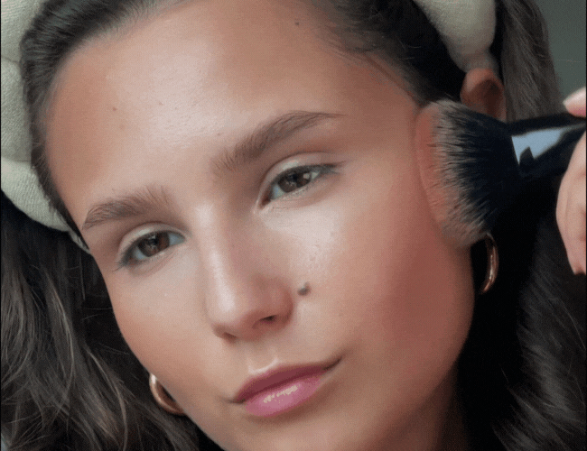 White lines on the face indicate where bronzer is applied to create a warm, fall latte look on the cheeks.