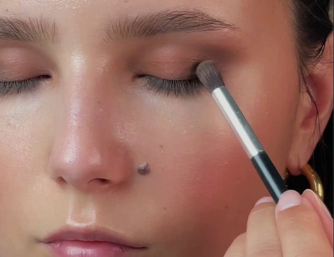 Model blends in dark, warm chocolate brown eyeshadow for more depth for her fall eye look.
