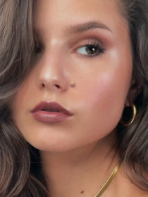 Model looks elegantly to the side.