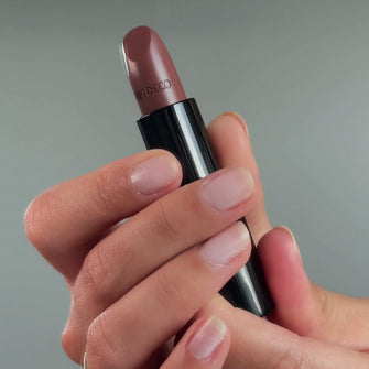 Hands holding Perfect Color Lipstick No. 842 - Dark Cinnamon.