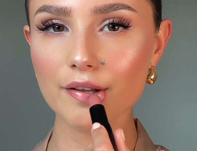 The lipstick is applied to the lips.
