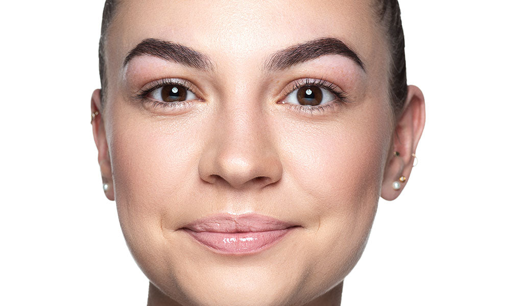 Smiling model without makeup looks into the camera.